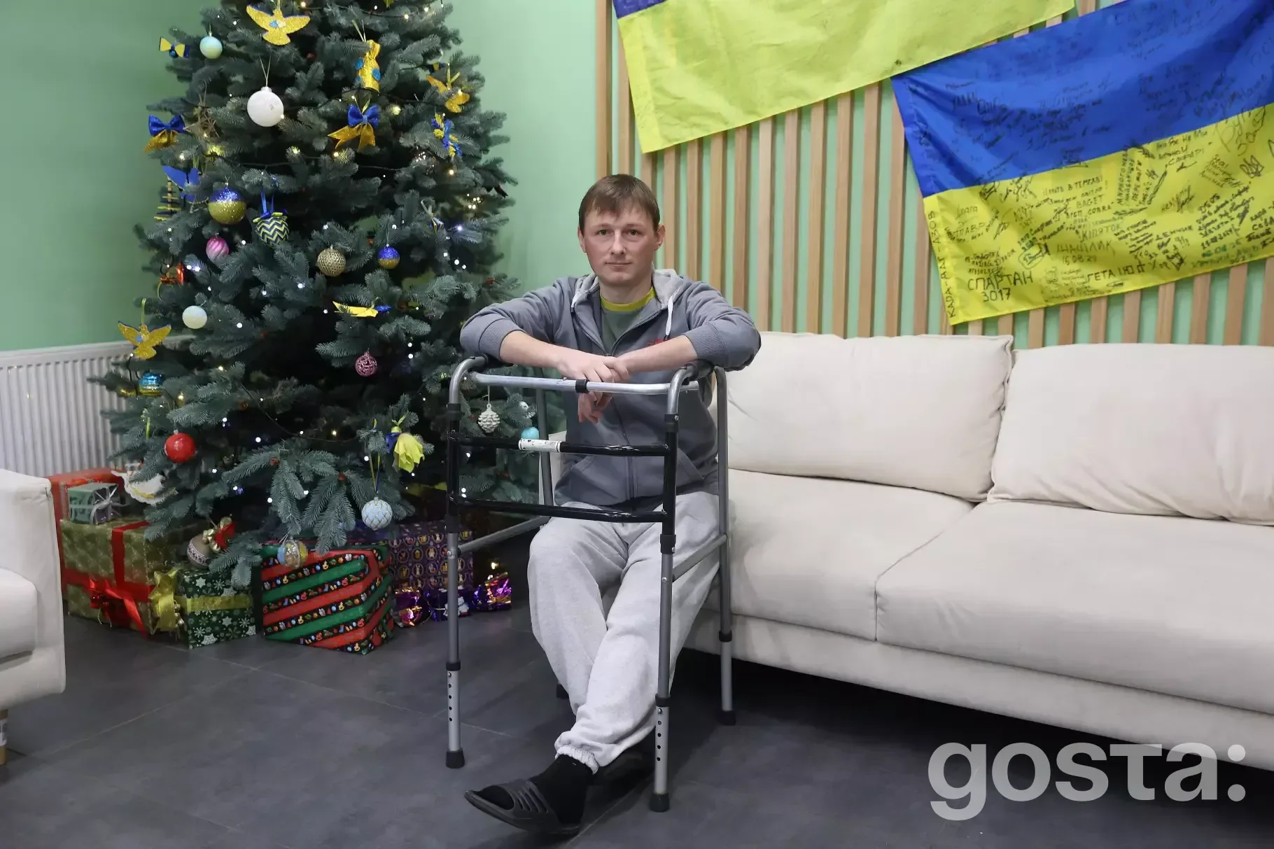 A soldier from the National Guard of Ukraine, sharing his recovery journey beside a Christmas tree, showcasing resilienc