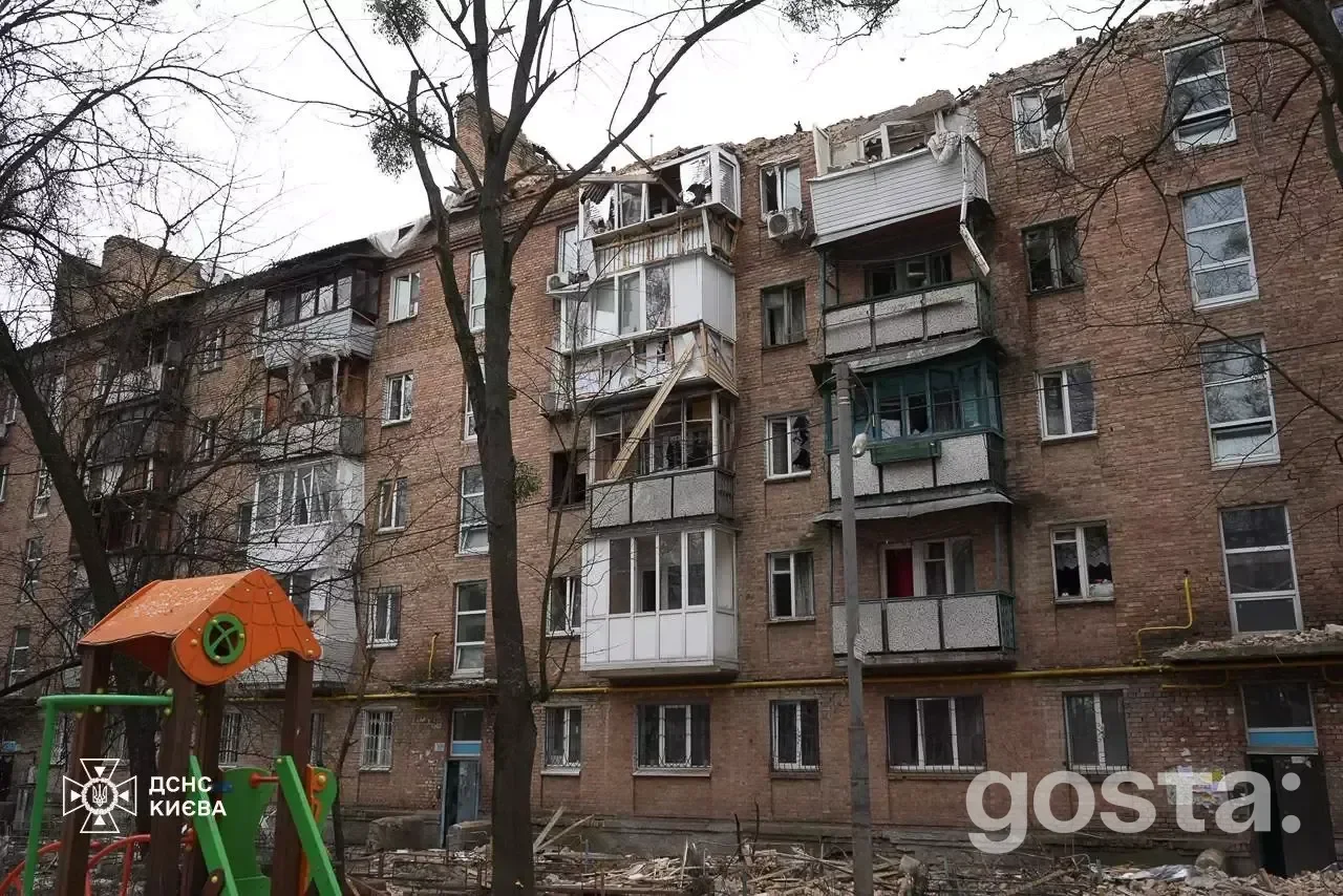 Damage to residential building in Kyiv after Russian attacks; rescue teams work on-site, addressing fires and impacts.