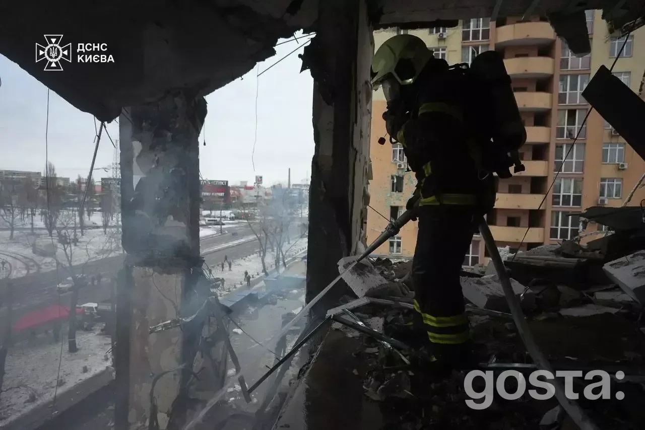 Emergency responders assess damage in Kyiv after a Russian attack, extinguishing fires and aiding evacuated residents.