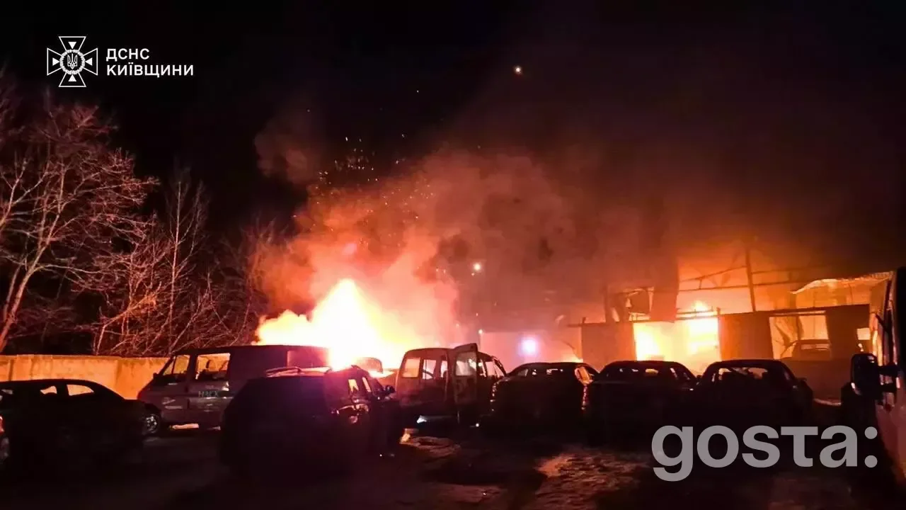 Emergency response amid chaos: fire and smoke engulf vehicles following a Russian attack in Kyiv, highlighting the devas