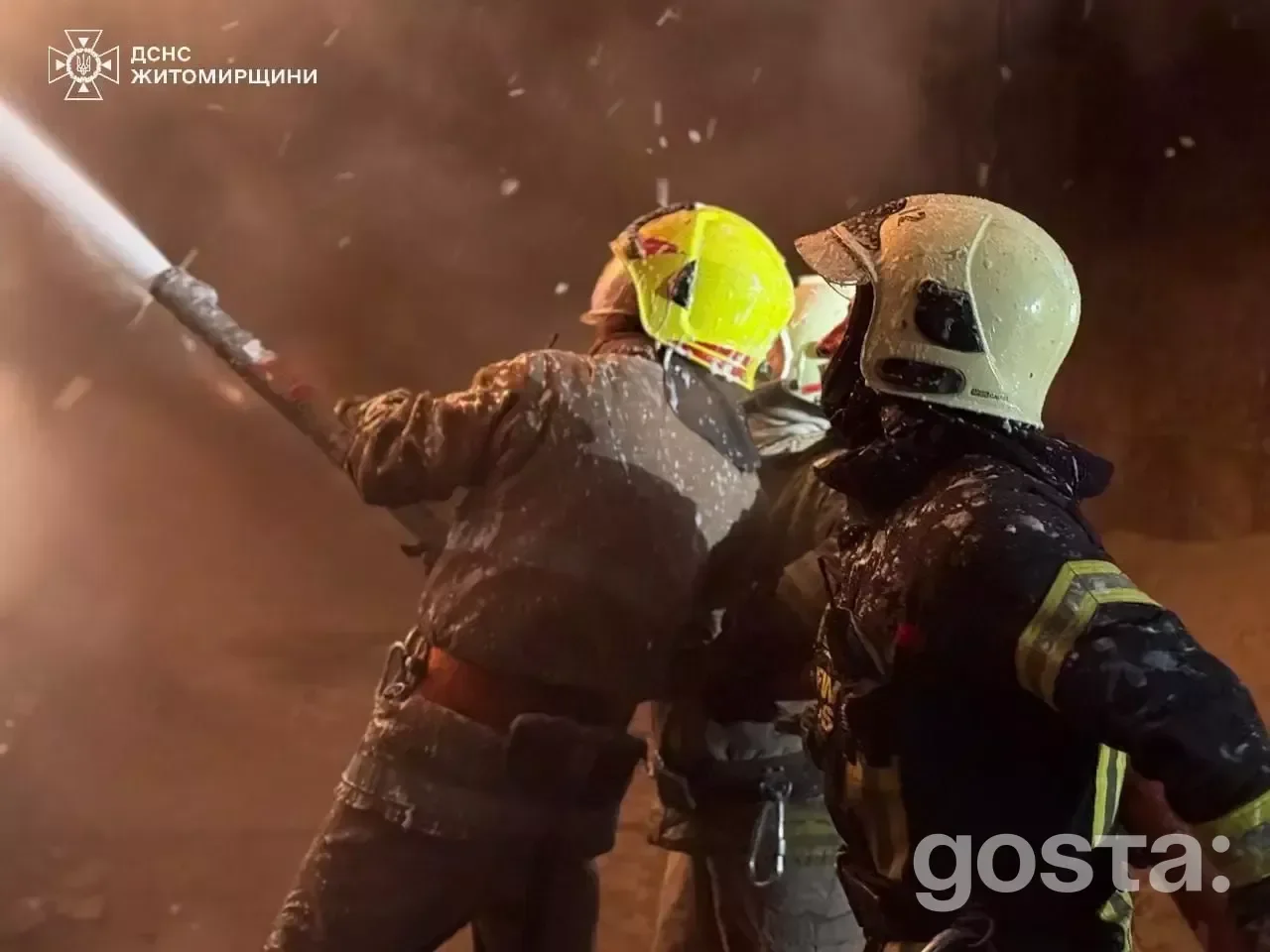 Firefighters combat an intense blaze at night caused by drone strikes in Ukraine, highlighting the ongoing conflict's im