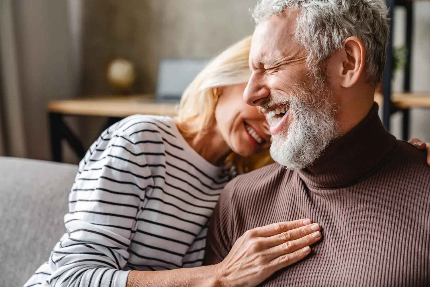 Happy couple smiling together, representing relationship health benefits