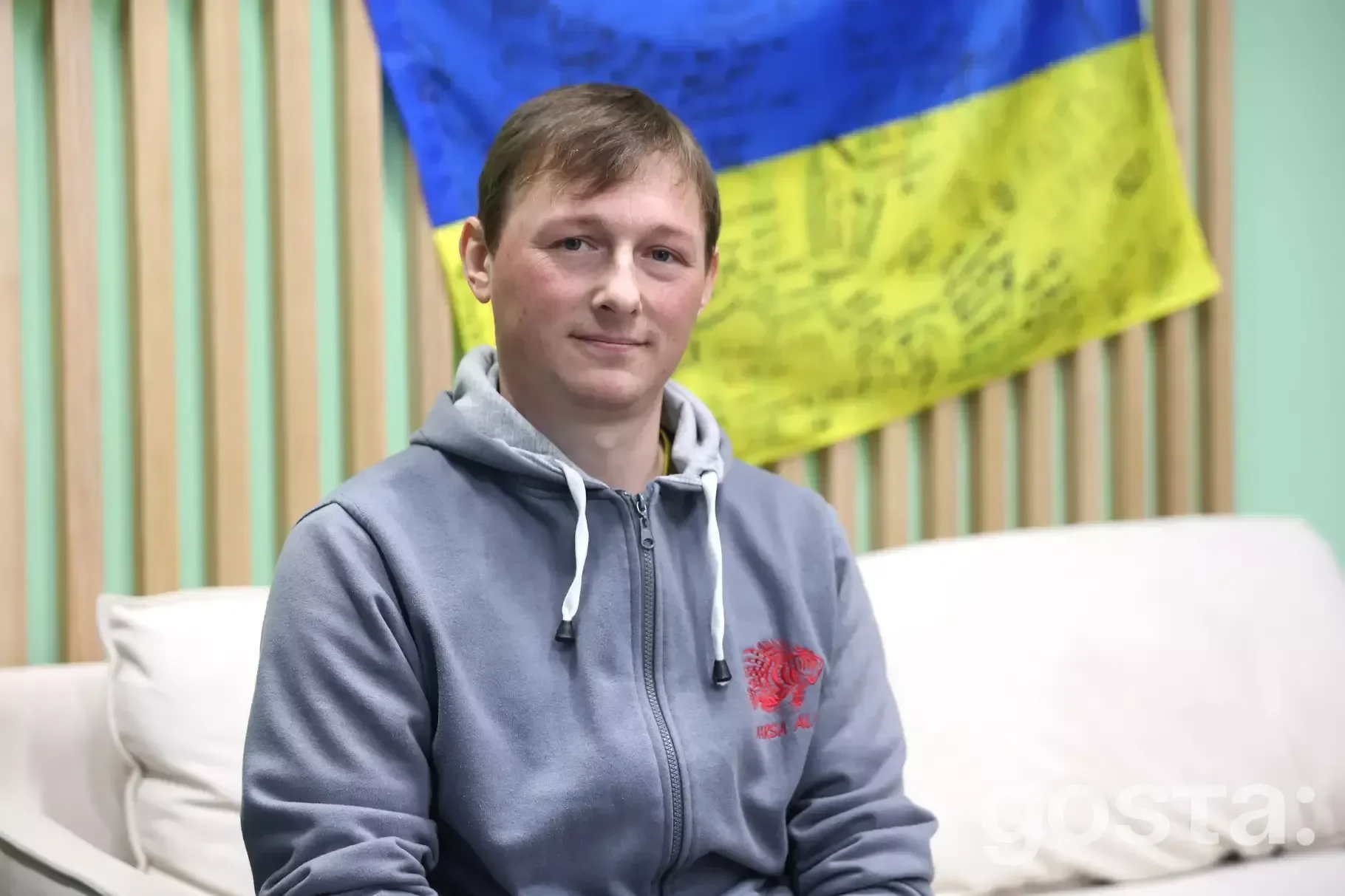 Portrait of a soldier from the National Guard of Ukraine, sharing his story amidst a backdrop of national pride.