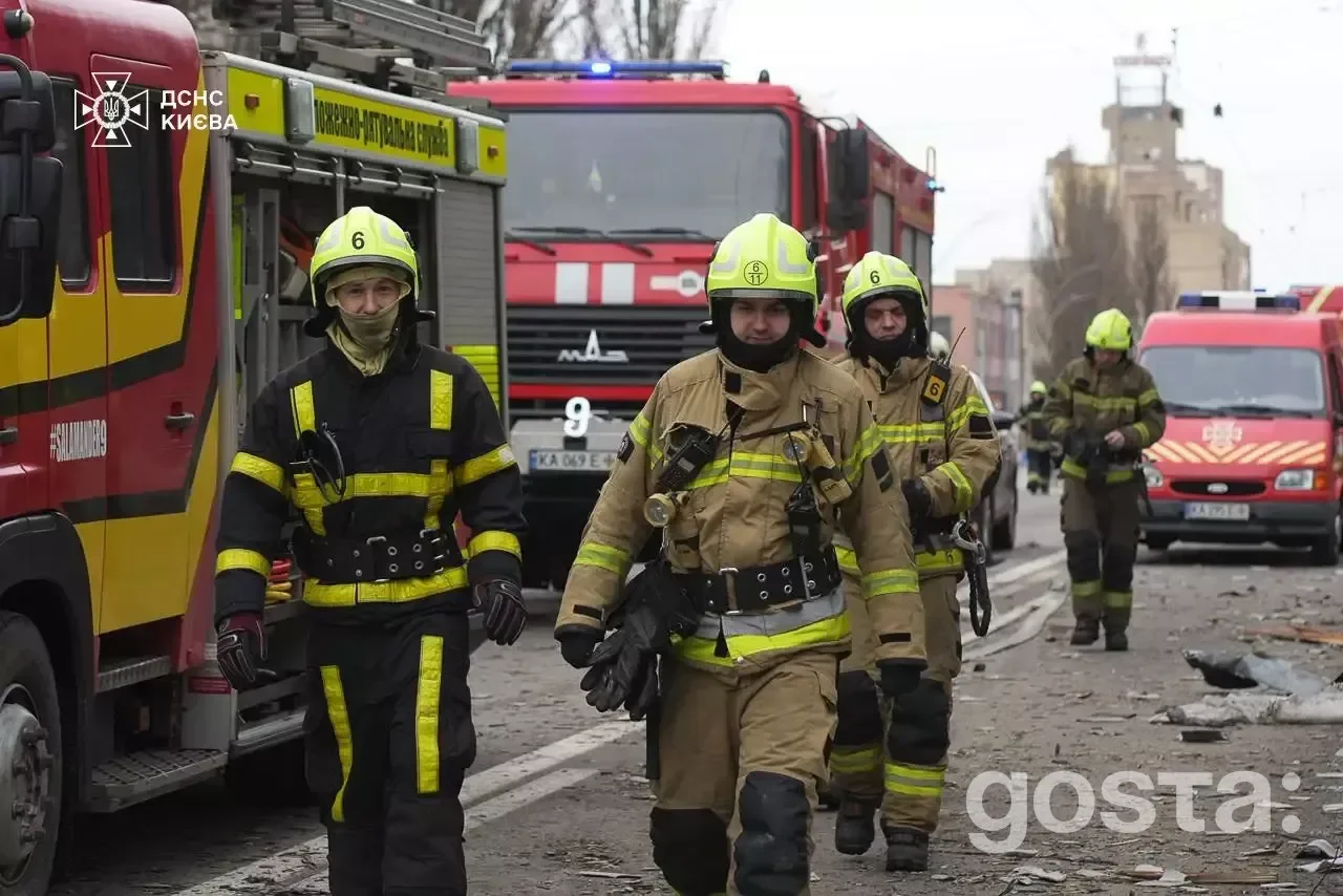 Rescue workers from Ukraine's State Emergency Service assess damage after a Russian attack in Kyiv, December 27, 2025.