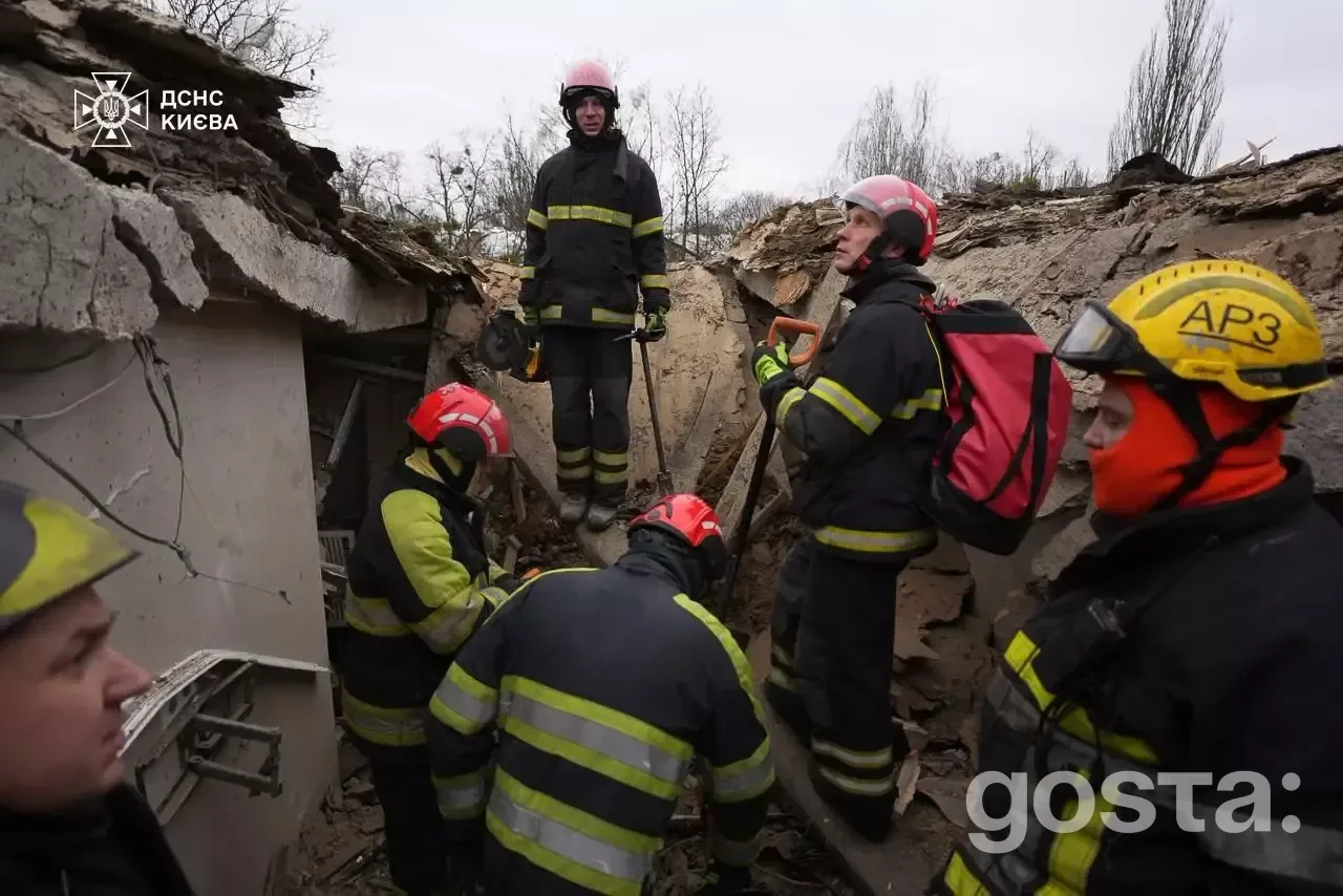 Rescuers and police working amidst the wreckage after a massive Russian attack on Kyiv, documenting damages and battling