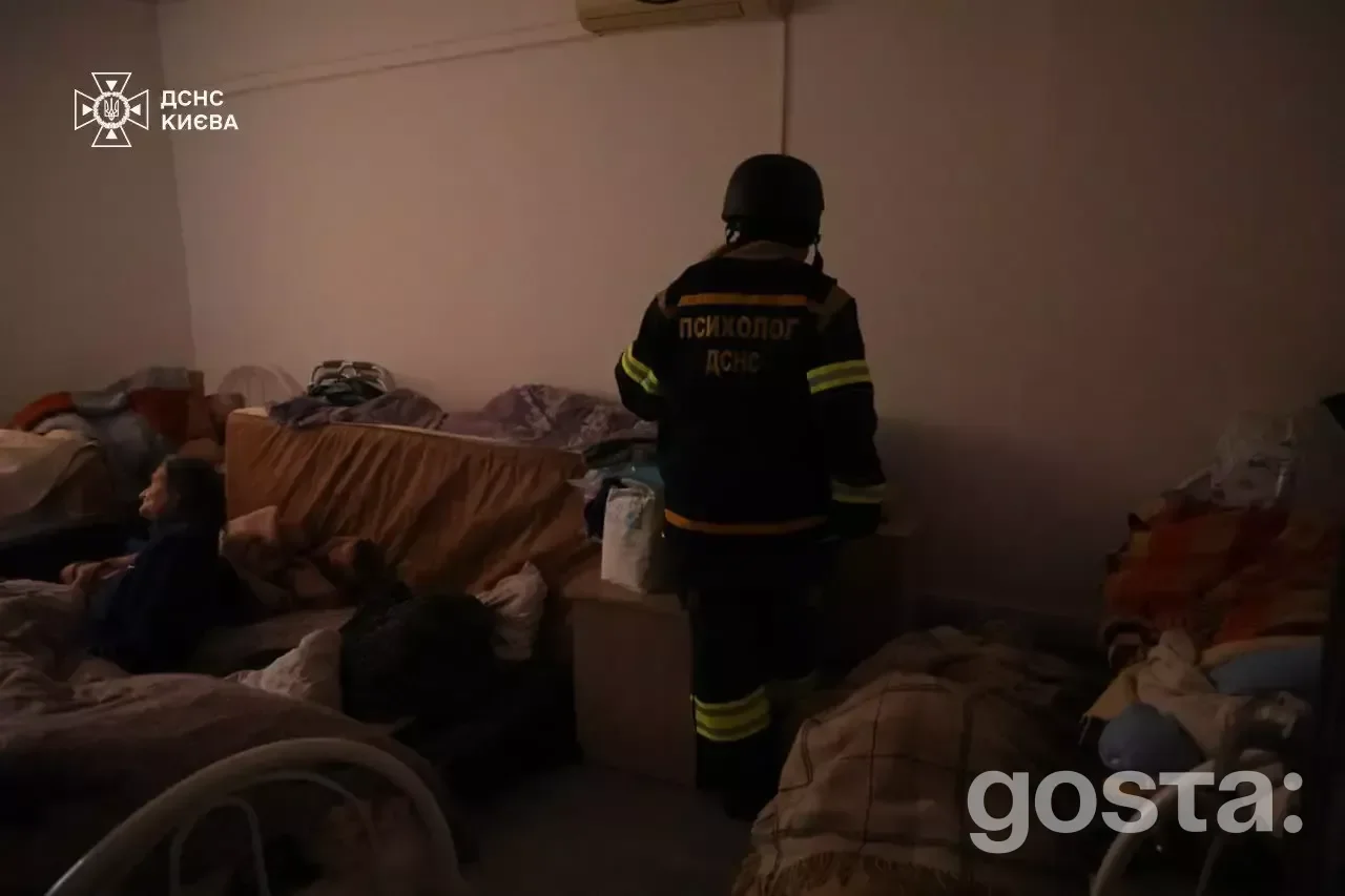 Rescuers from the State Emergency Service of Ukraine assess damage after a Russian attack, aiding injured citizens.