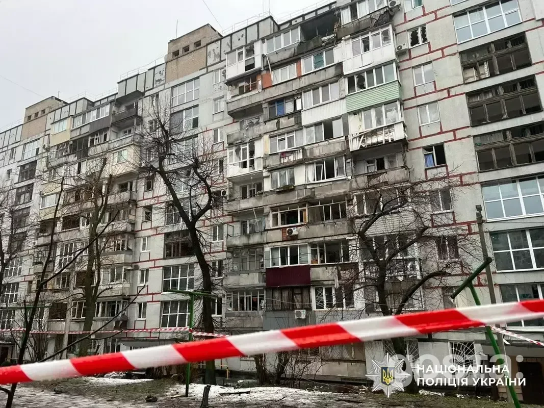 Severely damaged apartment building in Dnipro following a Russian attack, with emergency services present for assistance